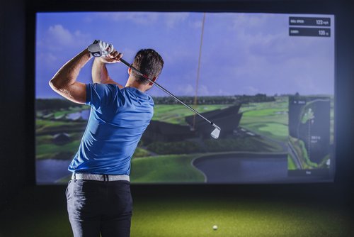 a golfer using trackman simulator at shotgun golf's year-round golf practice facility in North Toronto